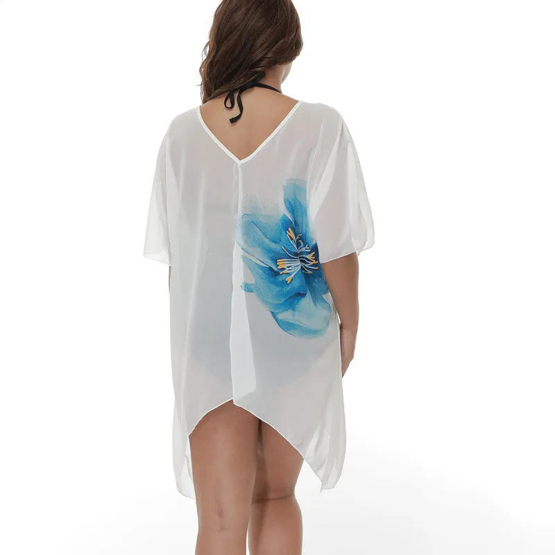 White plus size loose beach cover-up blouse on a hanger.