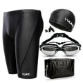 Men's black polyester swimming trunks set with anti-fog goggles, waterproof cap, ear plugs, nose clip, and carry bag.