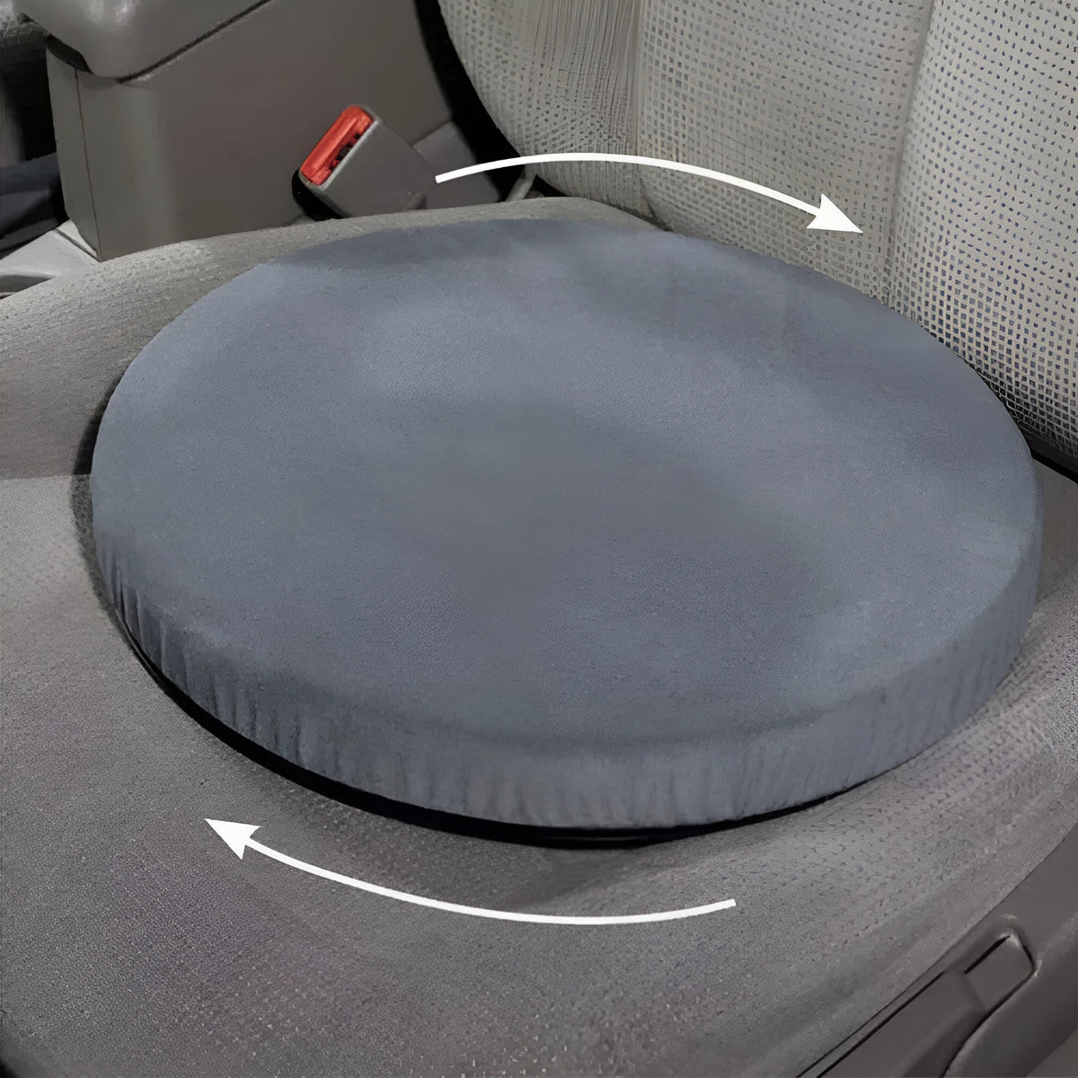 Round, grey rotating car seat cushion for elderly passenger assistance on a car seat.
