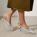 Black women's formal sandals with a cat heel, pointed toe, and buckle closure on a hollow-out upper.