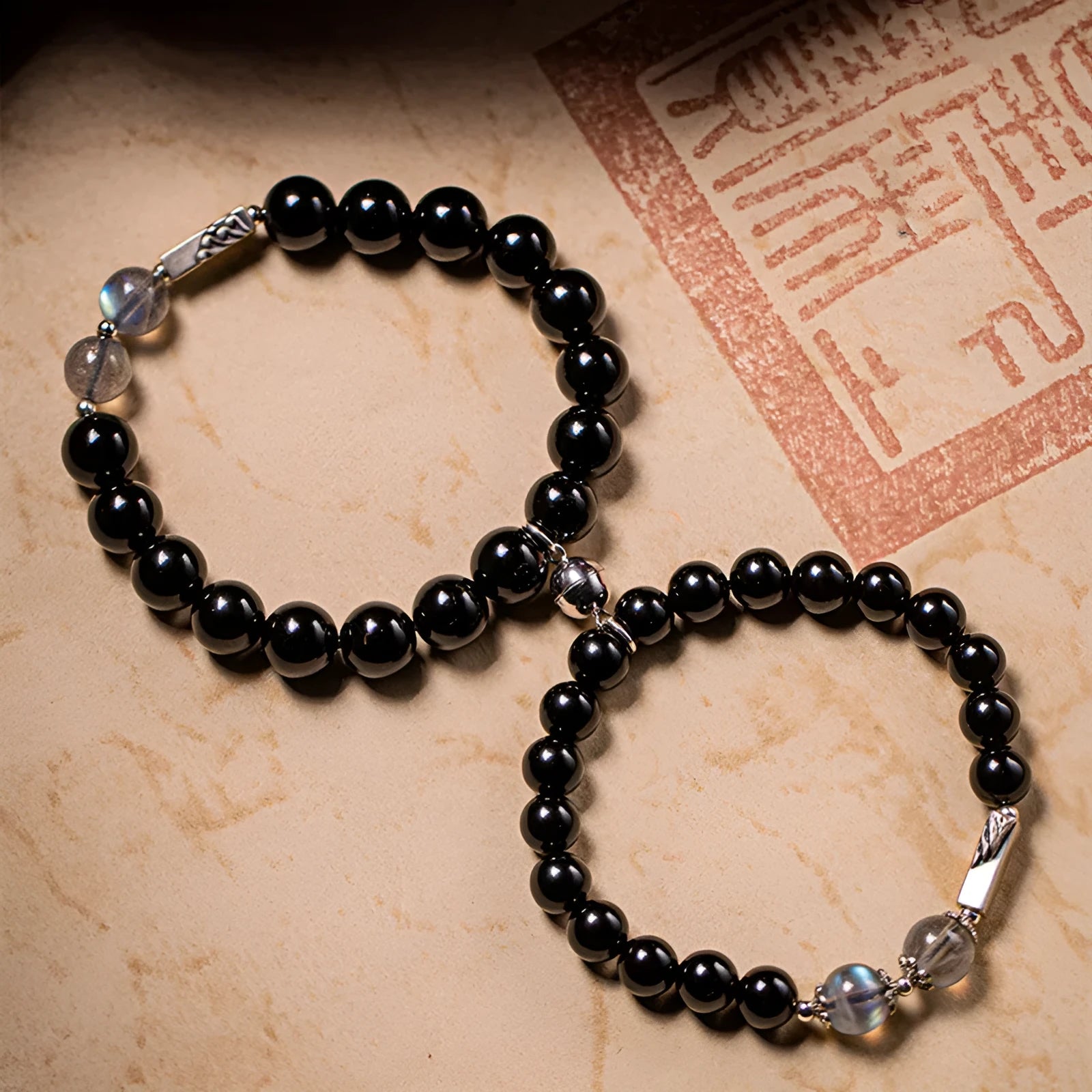 Black obsidian bead bracelets showing 8mm and 10mm sizes for couples in national style
