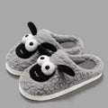 Brown suede slip-on slippers with a light-coloured sewn PVC sole on a wooden floor.