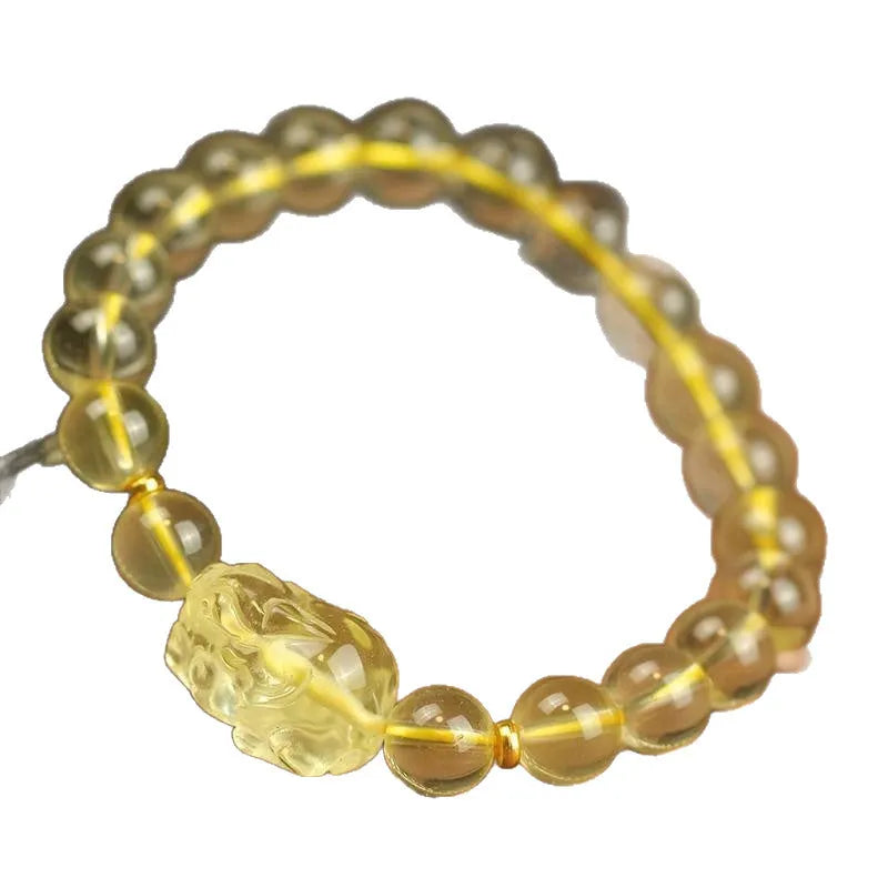 Yellow leather bracelet with a clear artificial crystal Pi Xiu charm in Chinese national style.