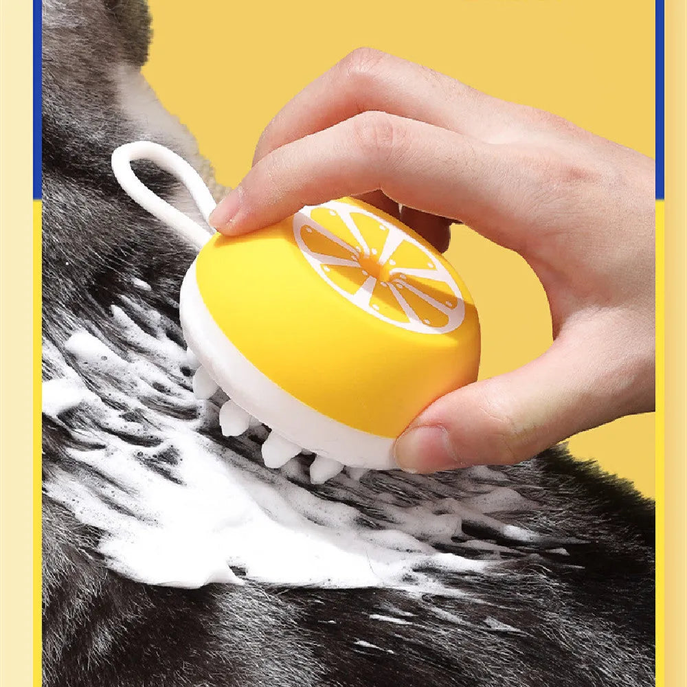 Yellow silicone pet bath brush with interchangeable heads for dog and cat grooming during washing