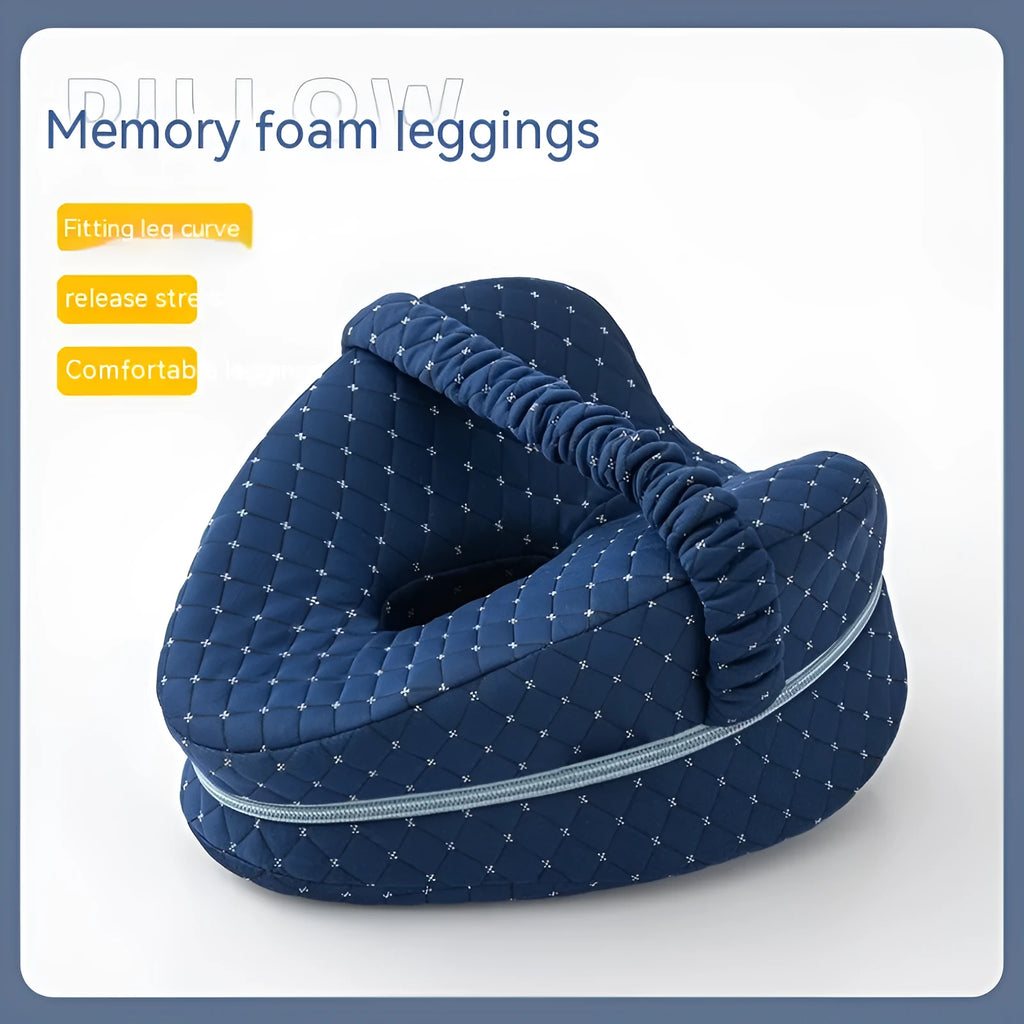Love heart-shaped dark blue memory foam leg pillow for adults on a bed.