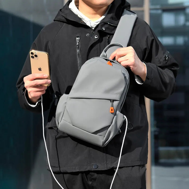 Men's black casual crossbody bag with an adjustable shoulder strap made from waterproof polyester.