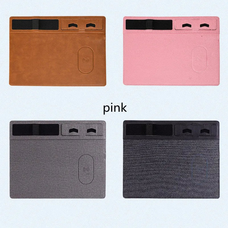 Pink wireless charging mouse pad with integrated phone holder on a desk