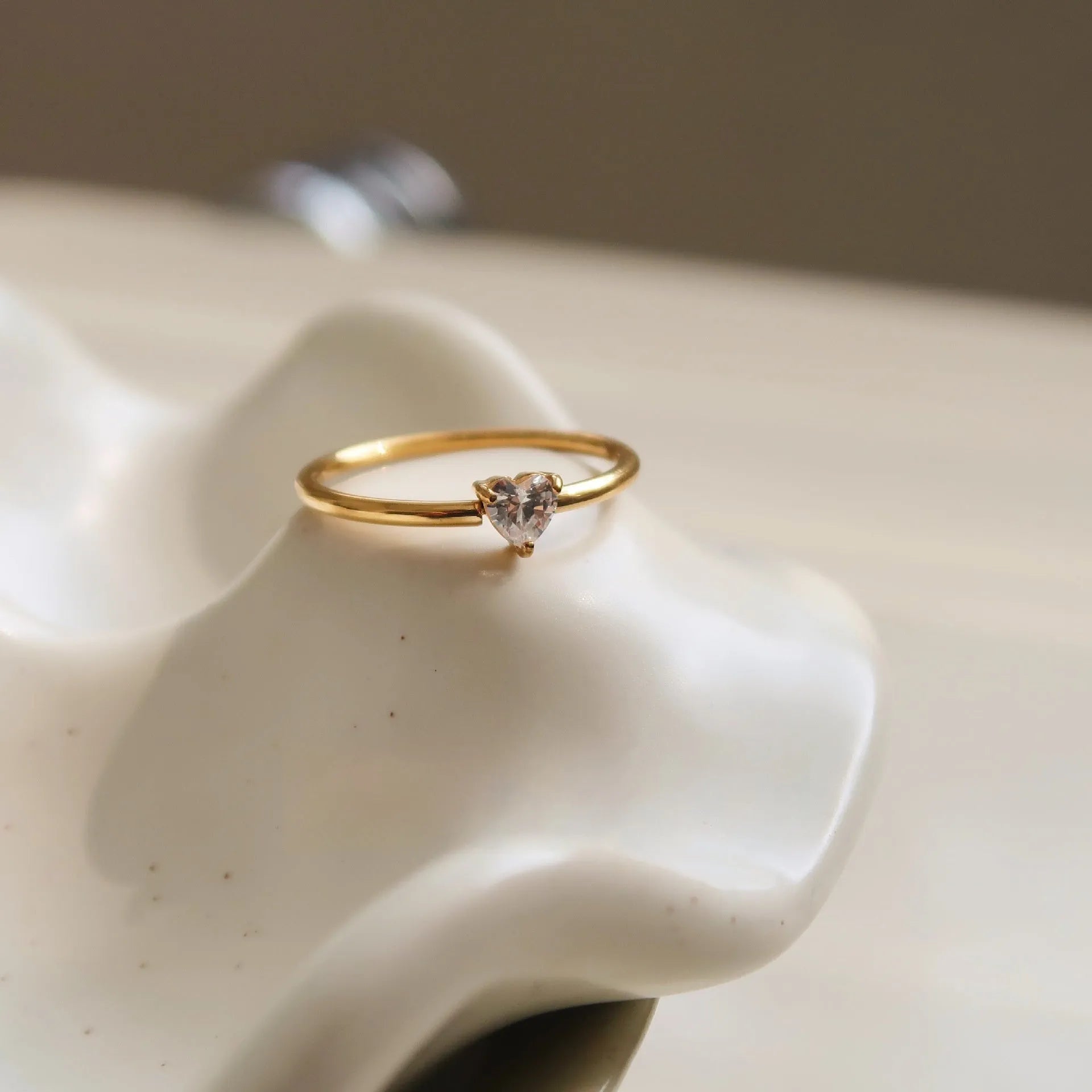 Golden electroplated stainless steel ring in love heart and oval shapes for women.
