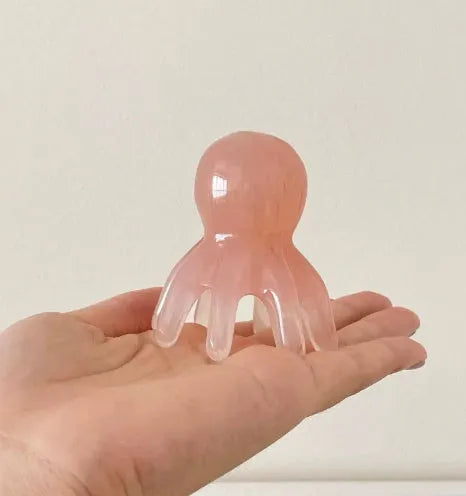Pink natural resin octopus massage comb for periocular meridian stimulation with storage bag