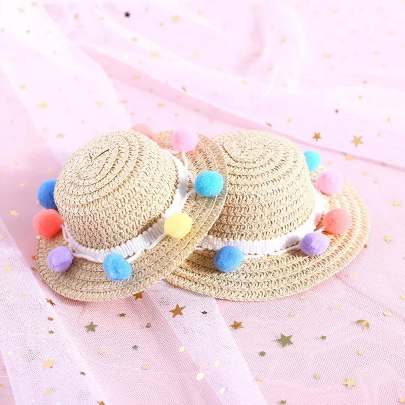 A colourful, handmade paper hat with a bowknot for a dog or cat on a white background.