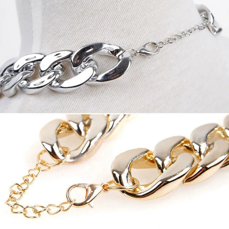 Geometric shaped gold colour dog collar with chain links and buckle on a white background.