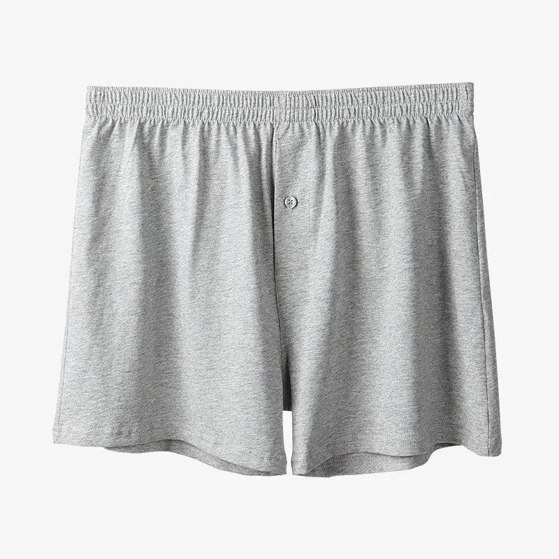 Men's loose-fit pure cotton boxer shorts in light grey, shown laid flat to display high-waist design.