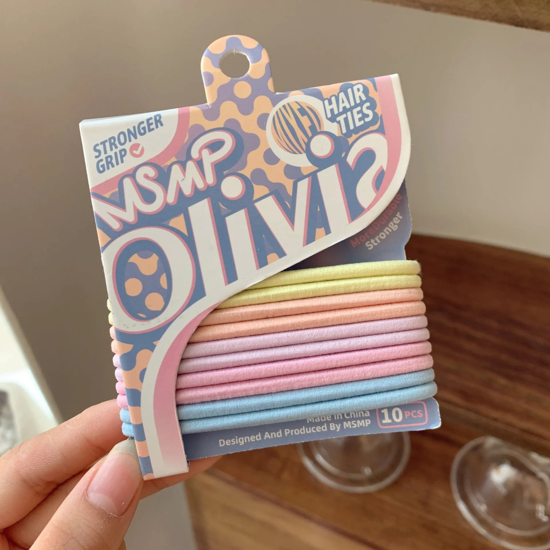 Assorted candy colour braided elastic hair bands for ponytails on a white background.