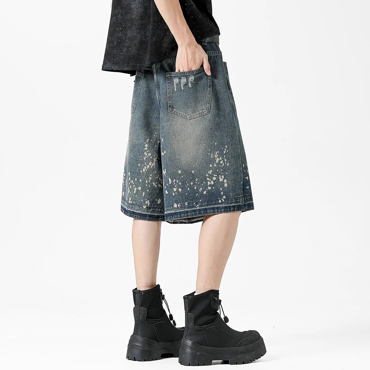 Men's retro blue denim shorts with ripped detailing and splash ink patterns on straight leg cut