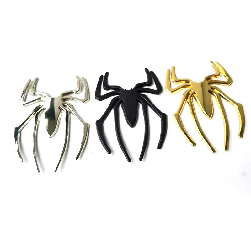 Three-dimensional metal spider bumper sticker in gold finish, measuring 7cm by 5cm.
