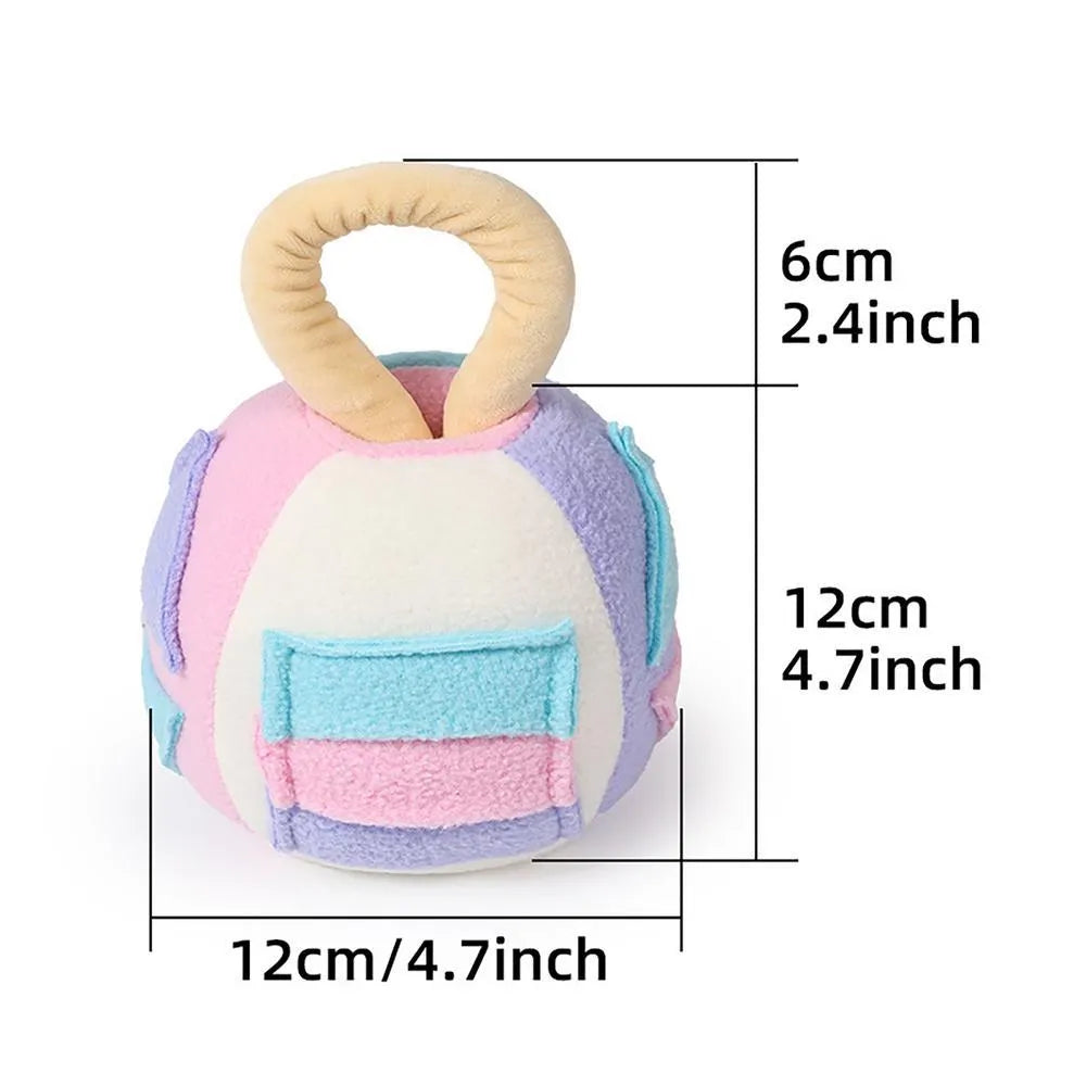 Green or pink polyester plush squeaky ball dog toy with treat pockets, shown next to a dog treat for scale.