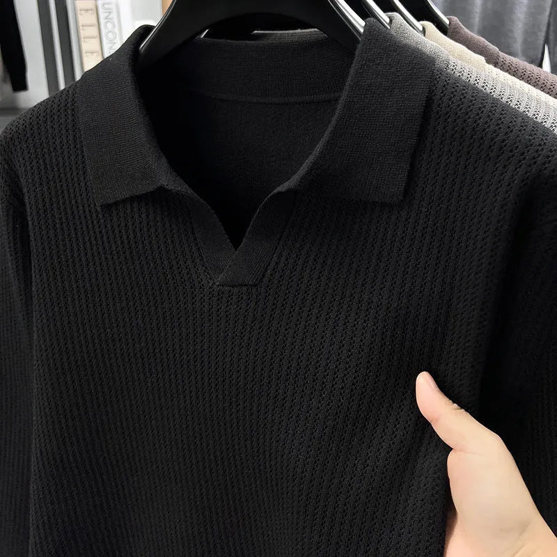 Men's loose green pullover sweater for casual autumn wear on a hanger