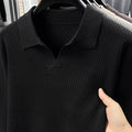 Men's loose green pullover sweater for casual autumn wear on a hanger