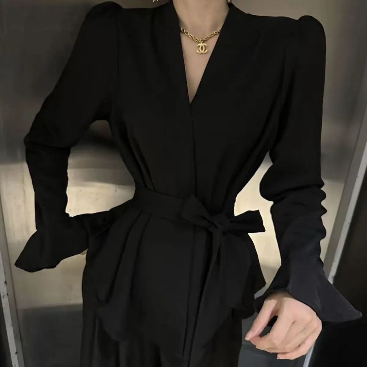 Women's black French-style shirt with irregular collar and long bell sleeves tied at waist