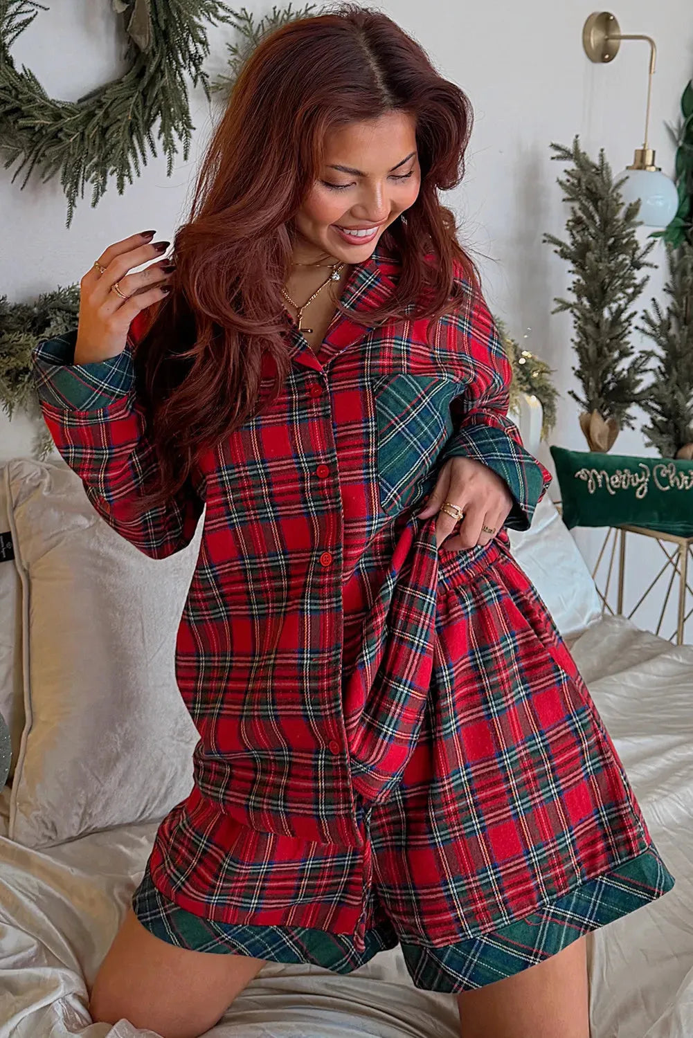 Red plaid Christmas pajama set with long sleeve shirt and shorts on hanger