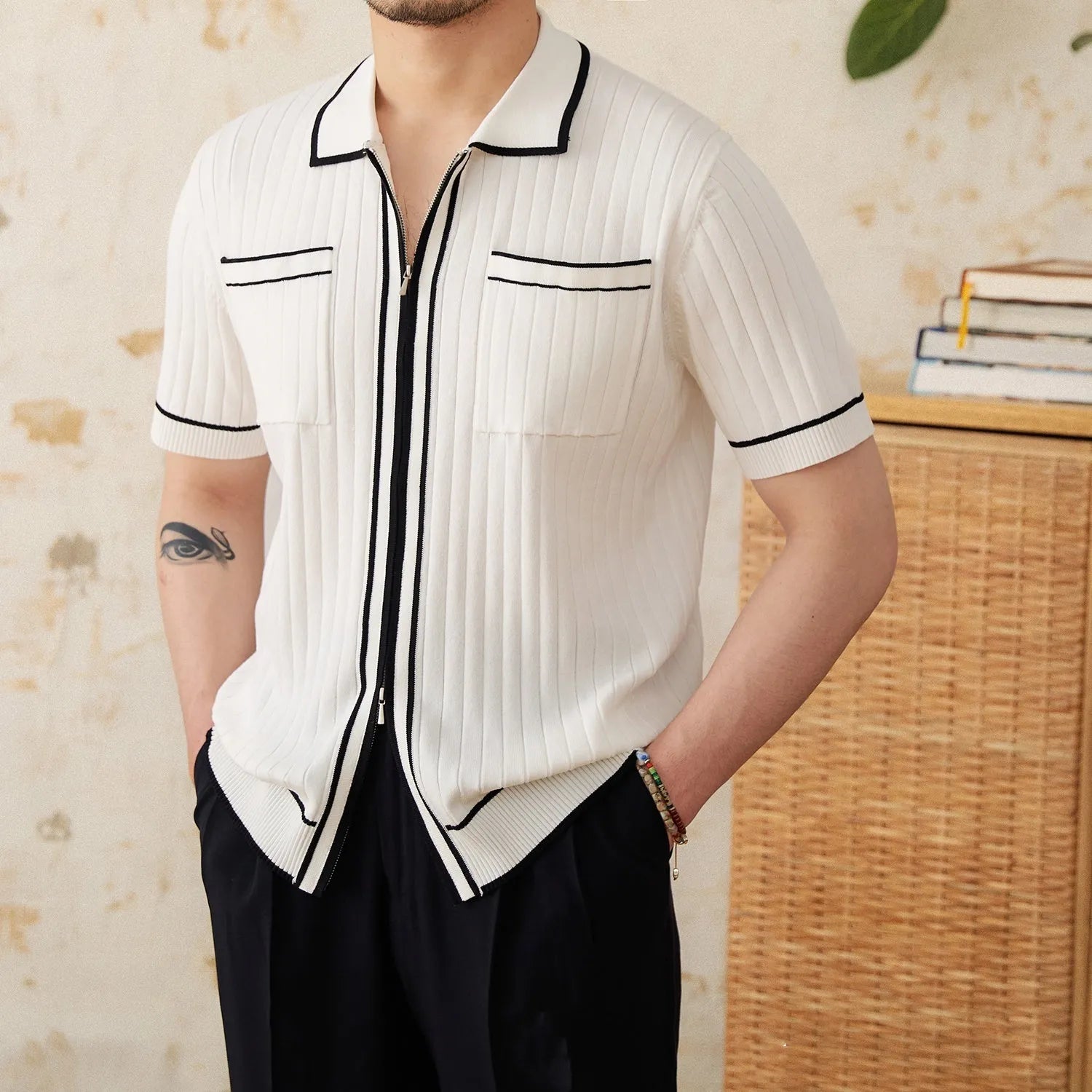 Slim black and white lapel polo shirt with short sleeves on a hanger