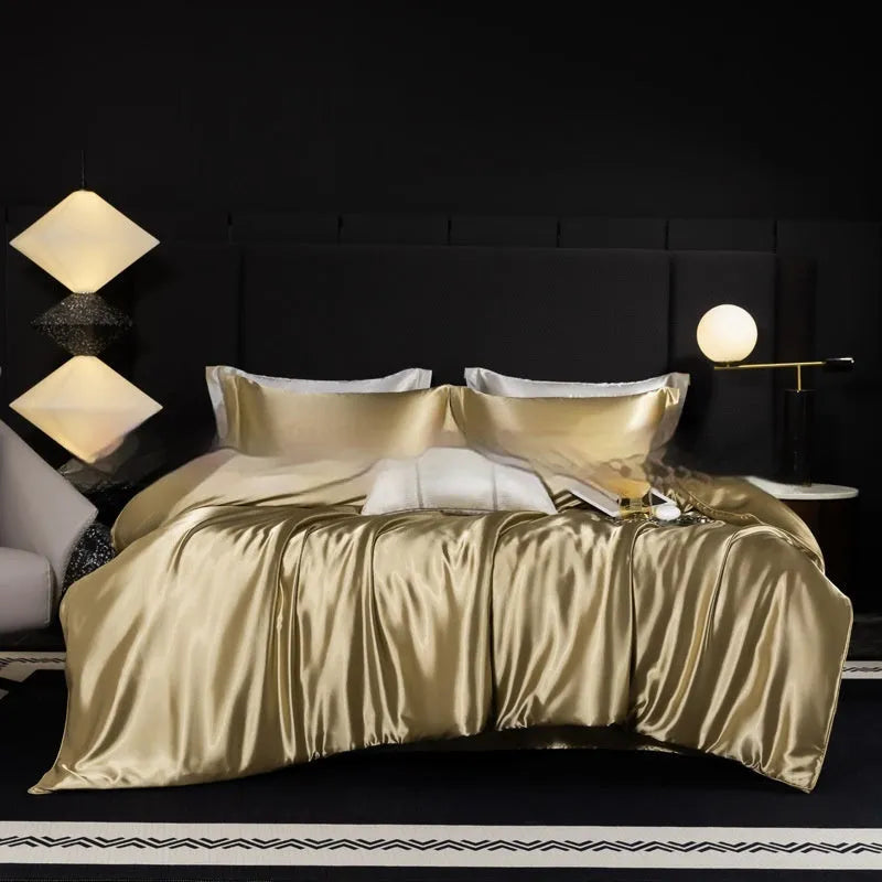 Silk four-piece bed sheet set in solid colour on bed with matching pillowcases and quilt cover