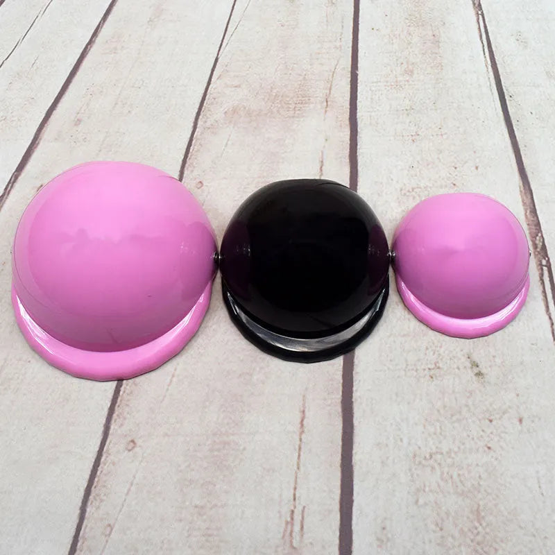A pink plastic dog helmet cap showing its rigid shape and solid colour, sized for a small dog.