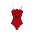 Red women's V-neck one-piece swimsuit with open back and a separate white skirt, featuring a detachable flower accessory.