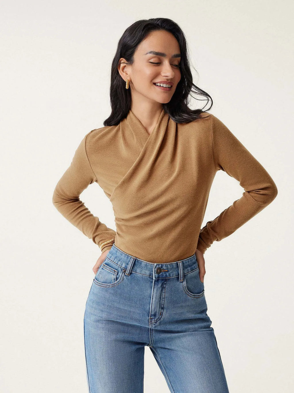 Camel-coloured women's slim-fit polyester pullover sweater on a hanger.