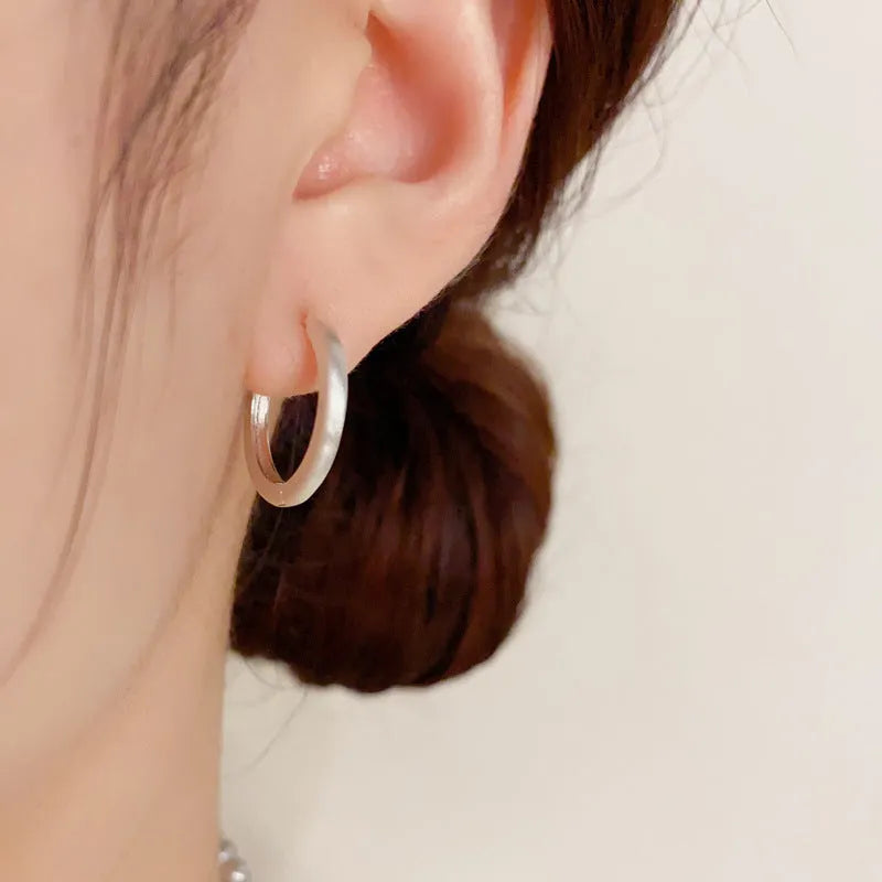 Women's geometric circle ear clip with round element in gold or silver finish, real gold plated copper minimalist jewellery