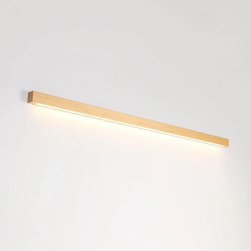 Modern walnut-colour wood log strip wall lamp with integrated LED lighting mounted on a wall.