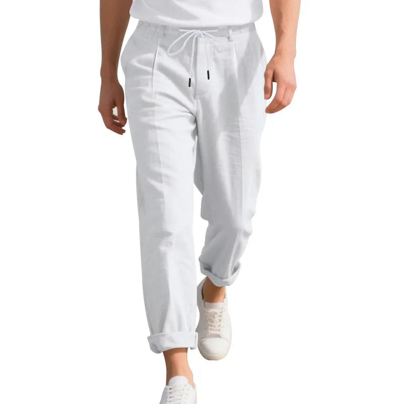 Men's loose-fit linen trousers in light khaki colour with a drawstring waistband.