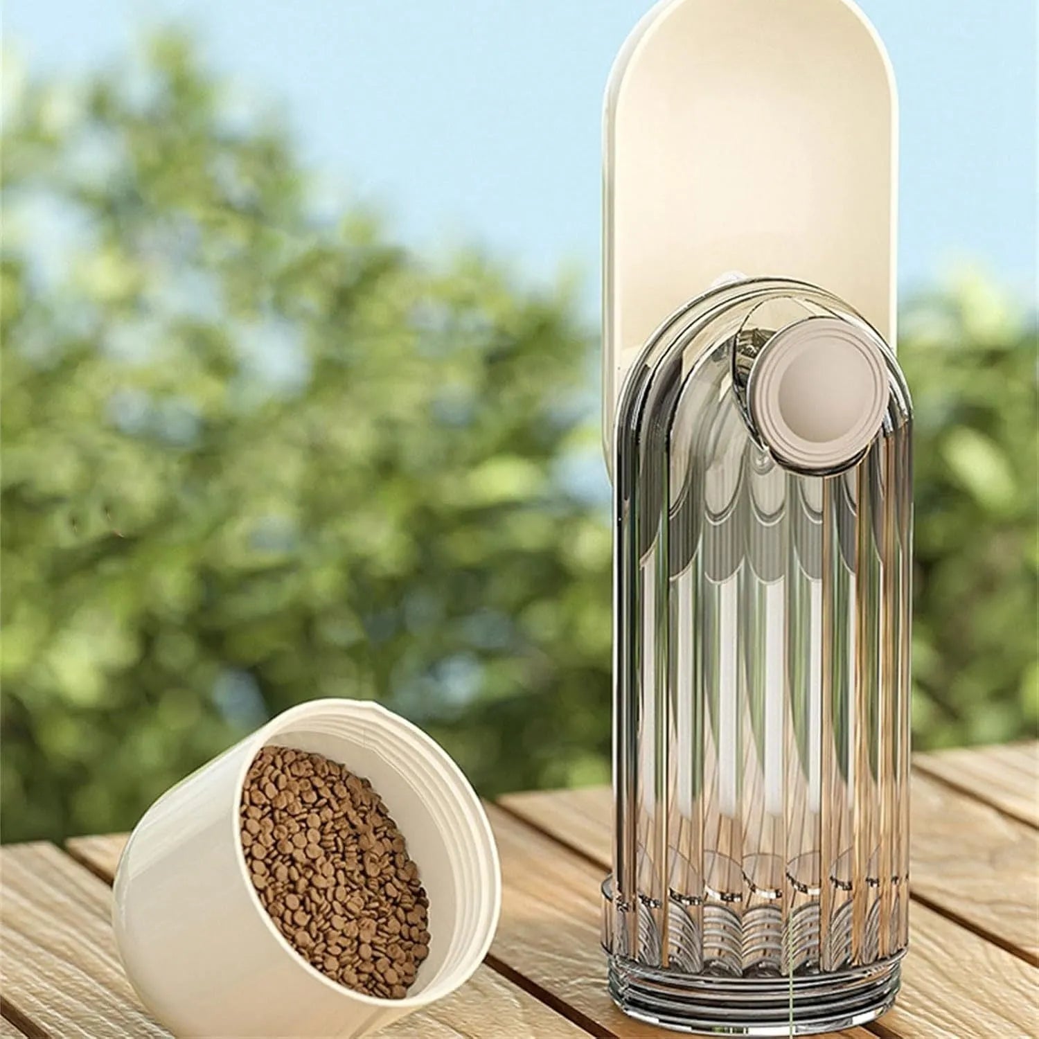 Beige foldable dog water bottle with food container at base, shown extended and collapsed.