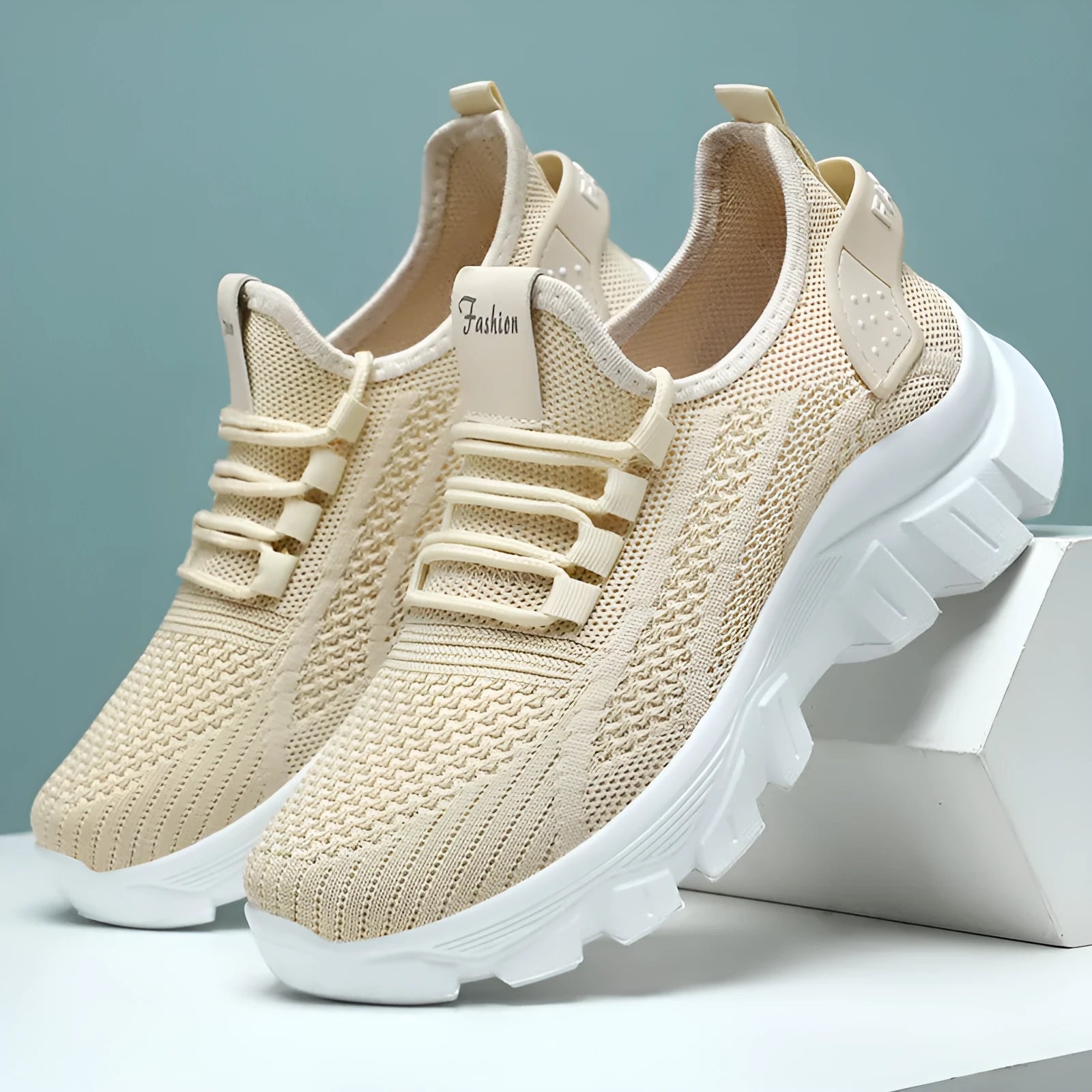 Women's white Flyknit running sneakers with thick PVC sole and lace-up front on a beige background.