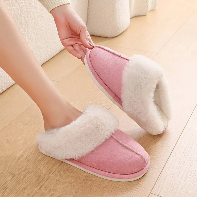 Women's plush winter slippers in pink with a round toe, flat heel, and anti-slip PVC sole.