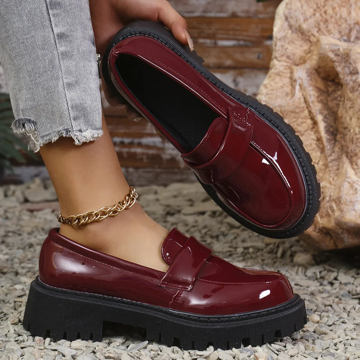 Women's plus size black slip-on loafers with a chunky platform heel and rubber sole.