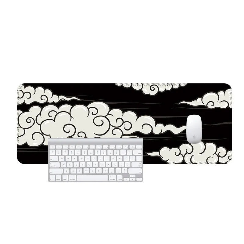 Large Japanese-style cloud pattern desk mat on a wooden office desk with keyboard and mouse.