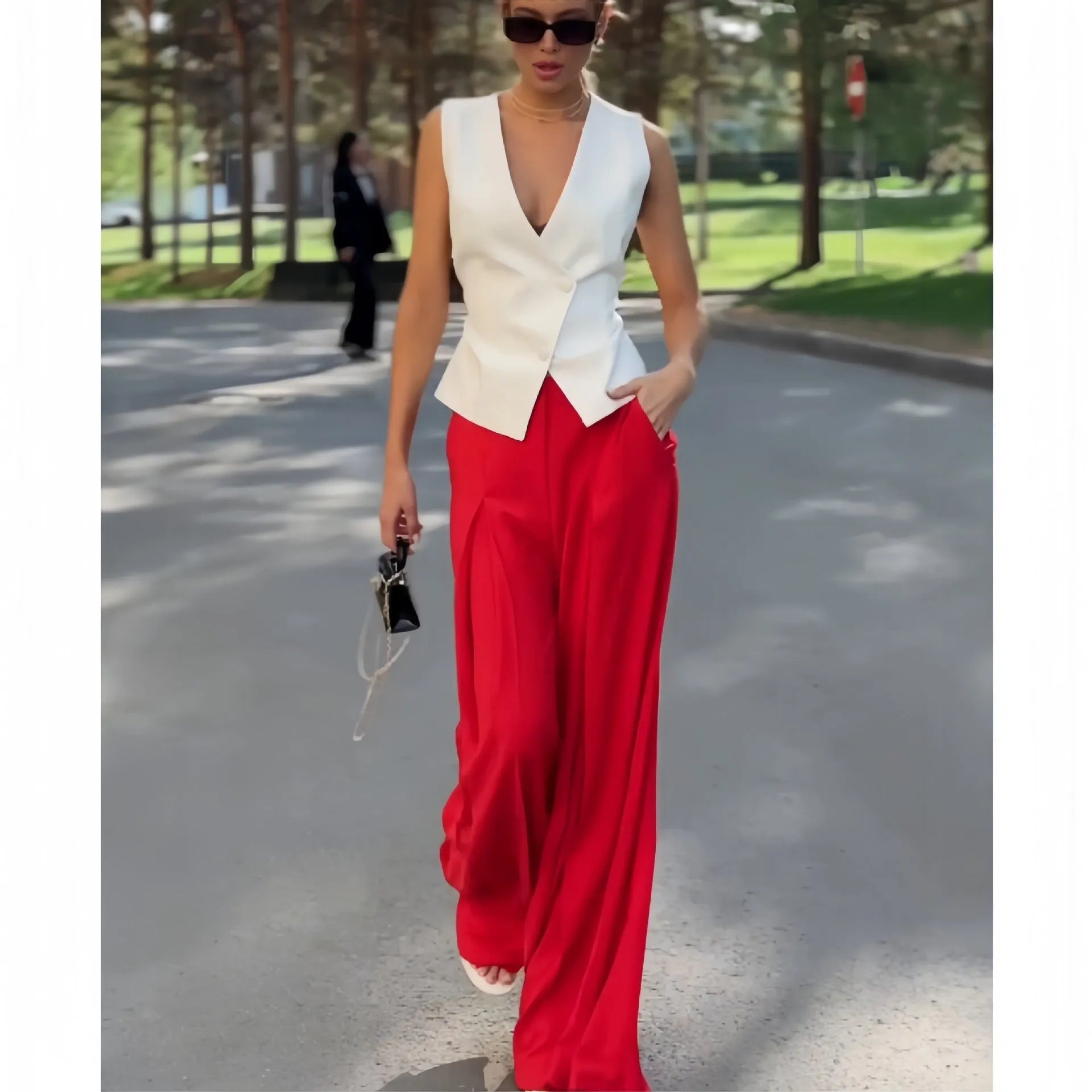 Beige women's sleeveless V-neck top and wide-leg high-waist trousers two-piece set laid flat.