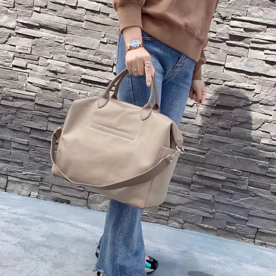 Black waterproof nylon shoulder bag with simple design and large 35cm height capacity