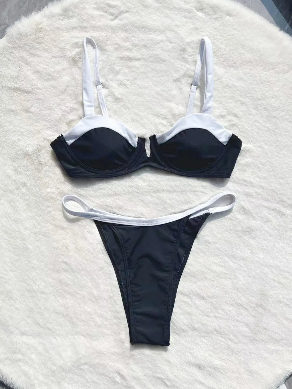 Black low waist bikini swimsuit with stitching split detail and briefs style cut