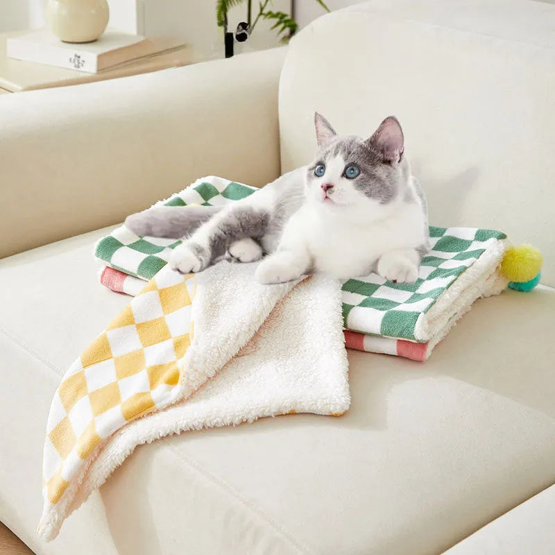 Plaid pattern pet blanket with fur ball decoration in green, pink, or yellow colours