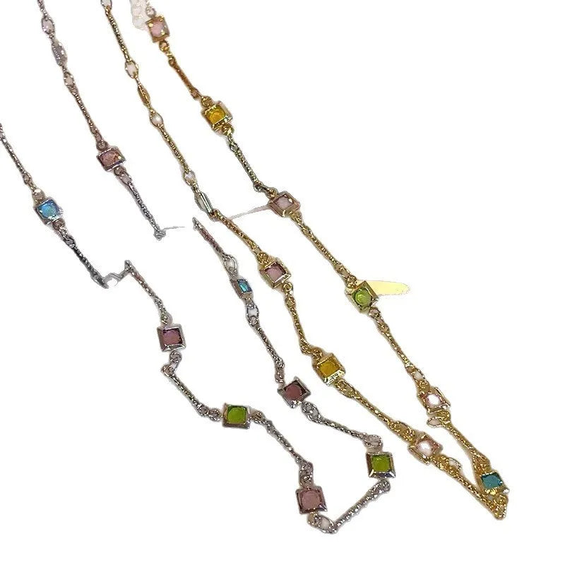 Square colour geometric clavicle chain necklace with artificial crystal details in gold tone.