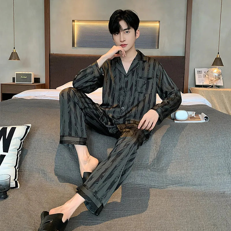 Men's black striped Ice Silk pajama set with long sleeves and trousers laid flat