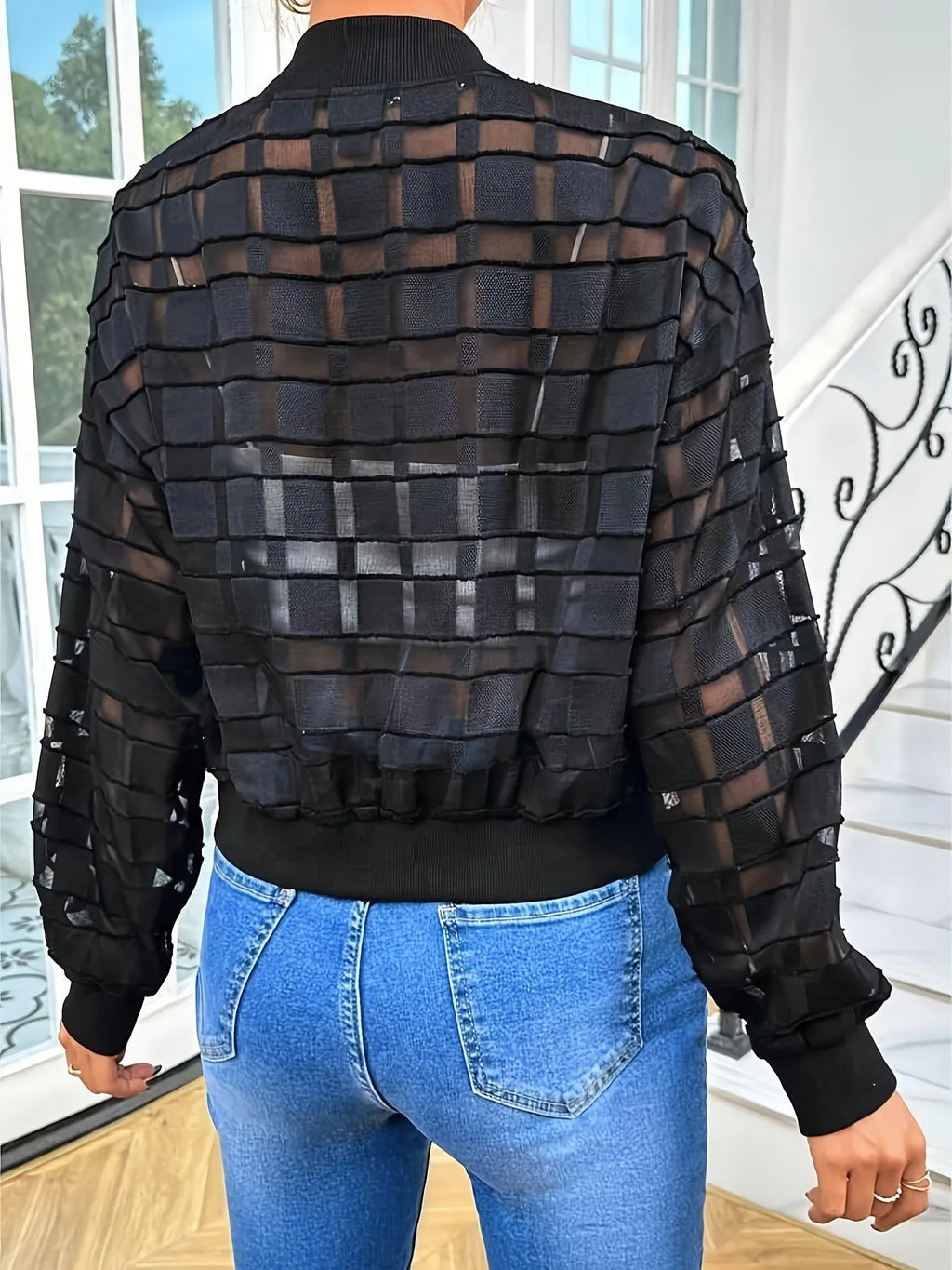 Black women's casual jacket with geometric pattern, semi-transparent fabric, and a full-length front zipper.
