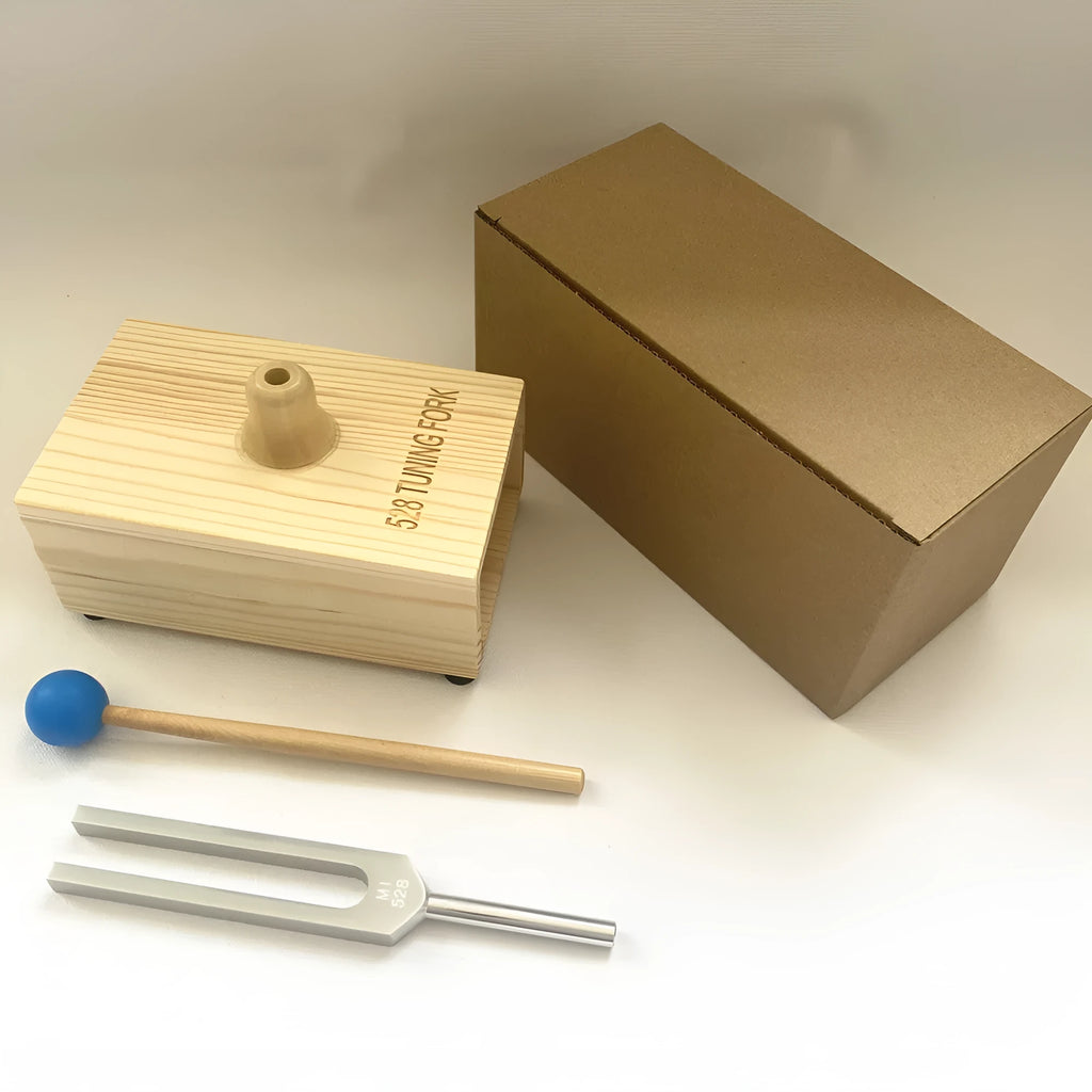 Aluminium alloy 432 Hz tuning fork with a matching speaker unit on a kraft paper box.