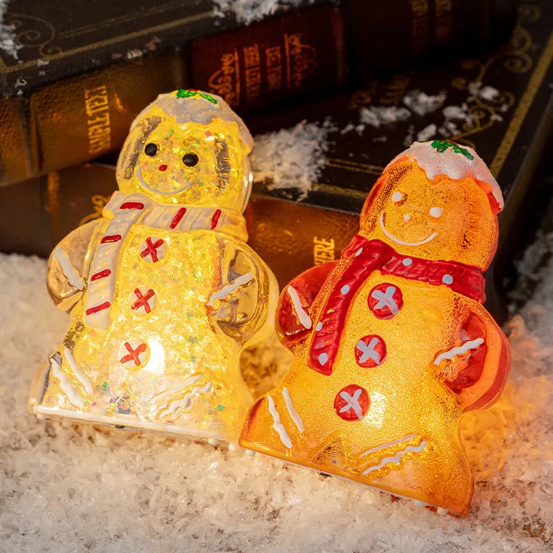 Set of four glowing plastic Christmas ornaments: gingerbread men and snowmen with red, white, and transparent scarves.