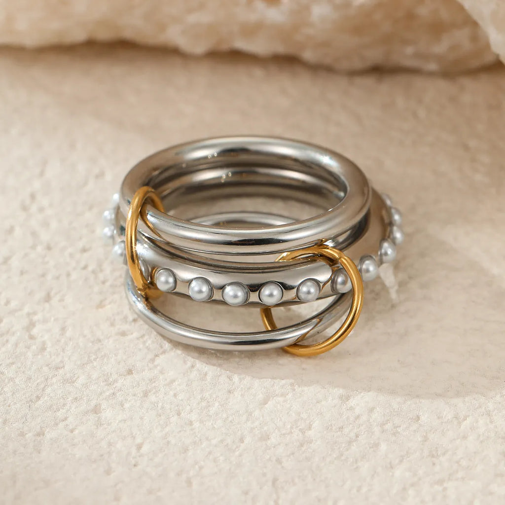 Gold plated stainless steel stackable ring for women in an exaggerated design on a hand.