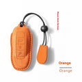 Suede car key cover in cement grey, dark green, light grey, and orange colour options.
