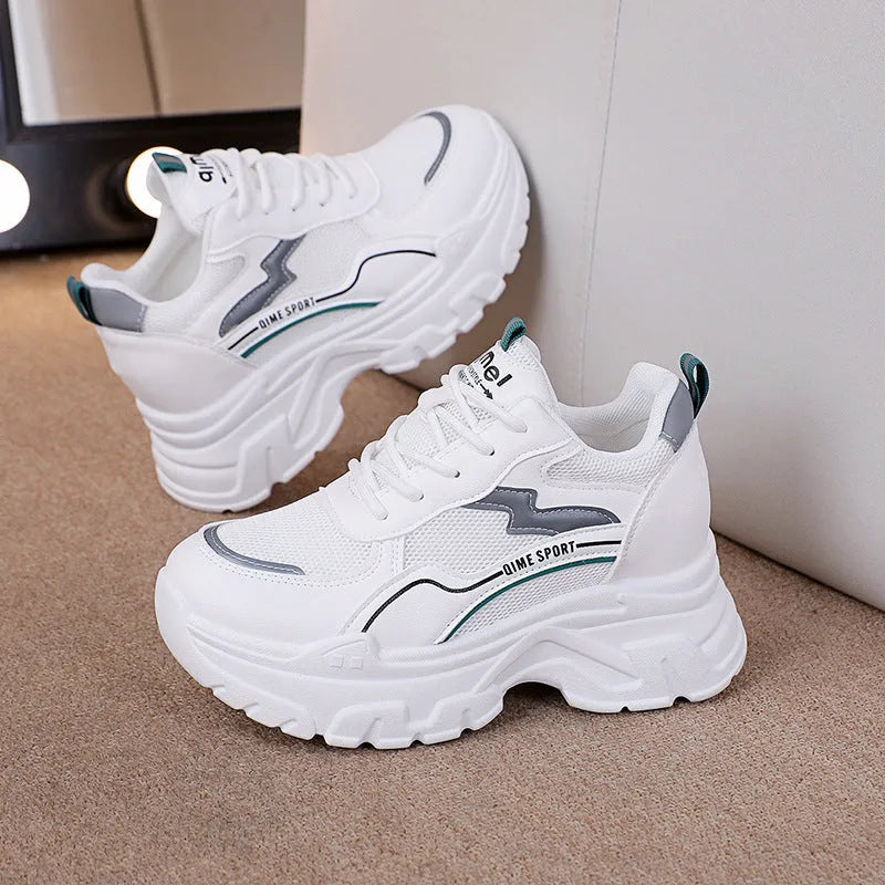 White women's dad shoes with cross shoulder straps and lace-up front on a rubber sole.