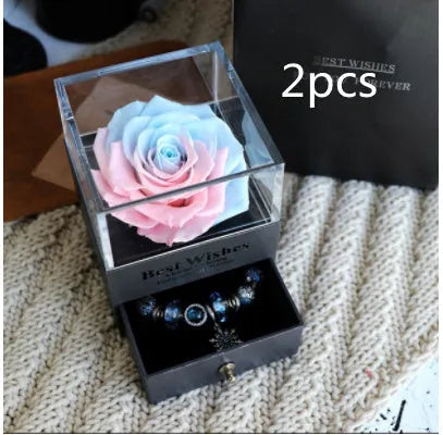 Glass eternal flower jewellery box with preserved roses and carnations inside measuring 8.5cm square